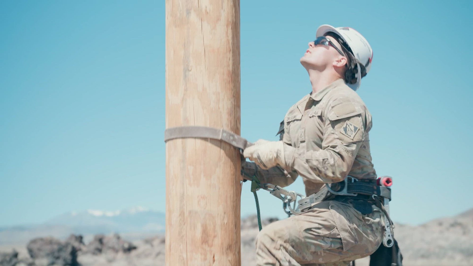 U.S. Army Reserve Soldiers, assigned to Delta Company, 249th Engineer Battalion, install single-phase power lines on the Navajo Nation Reservation. The Soldiers installed more than two miles of conductor as part of an ongoing mission to expand electrical infrastructure across tribal lands by installing approximately 150 main distribution power poles and lines over a 10-mile stretch, helping connect homes within the Navajo Nation to reliable electricity. (U.S. Army Reserve video by David Cook)