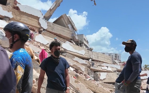 Urban Search and Rescue teams continue the search for survivors using every available tool