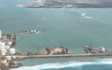 U.S. Coast Guard HC-130J Hercules crew overflies Port of Guam post Super Typhoon Bavi