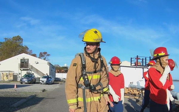 Damage Controlman "A" School train with firefighting equipment
