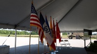 Flags lined up in preparation for the groundbreaking ceremony for the new Future Artillery Complex at Iowa Army Ammunition Plant.