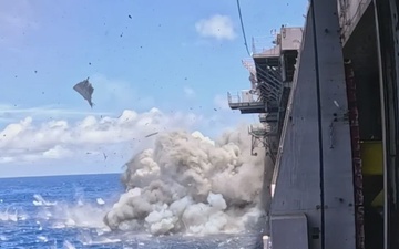 B-Roll: Decommissioned USS Peleliu struck by Harpoon anti-ship cruise missiles during RIMPAC 26 sinking exercise