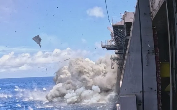 B-Roll: Decommissioned USS Peleliu struck by Harpoon anti-ship cruise missiles during RIMPAC 26 sinking exercise