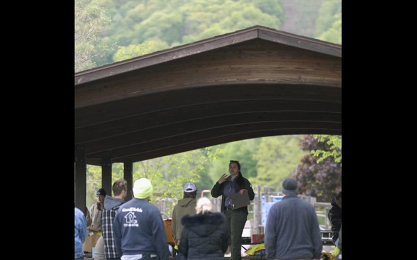 Volunteers and U.S. Army Corps of Engineers staff remove debris from the shoreline of Raystown Lake