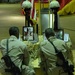 Two soldiers kneel at memorial