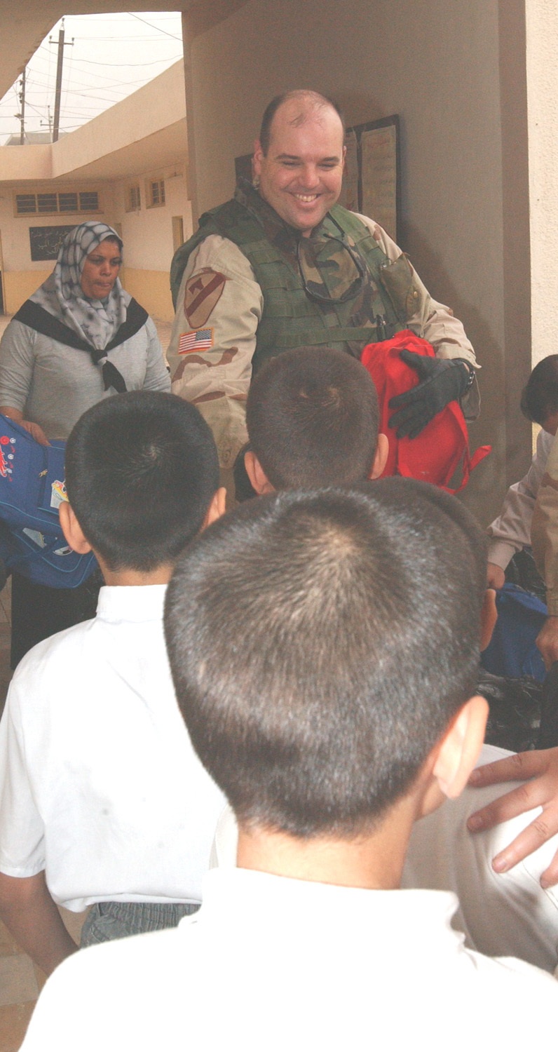 Capt. McPherson passes out backpacks