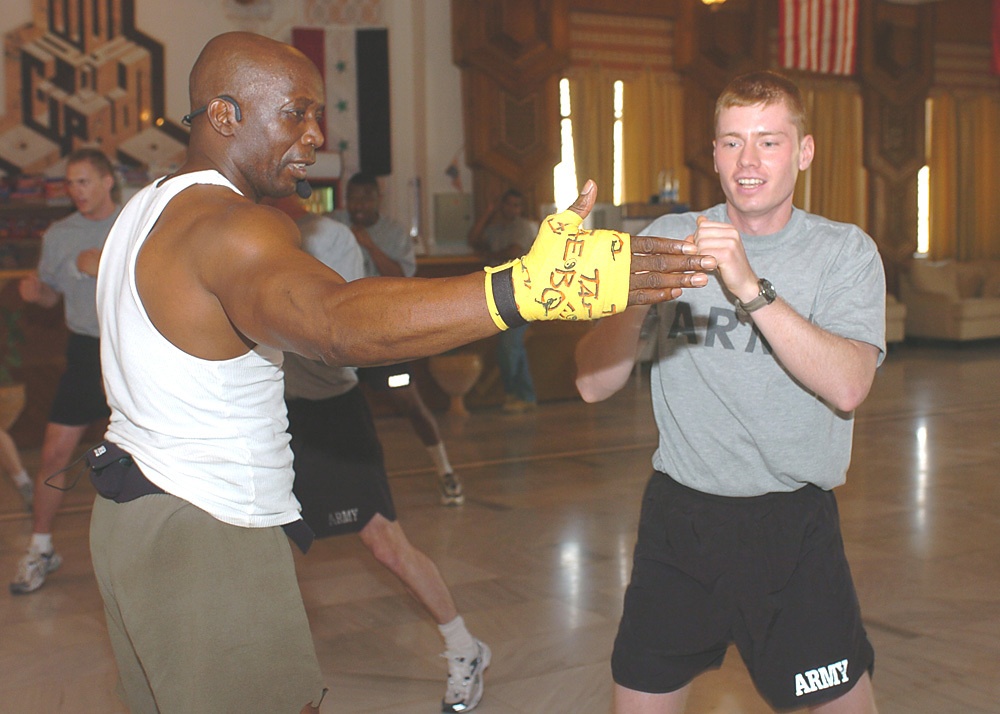 Sgt. Jordan M. Lenhoff strikes Billy Blanks hand