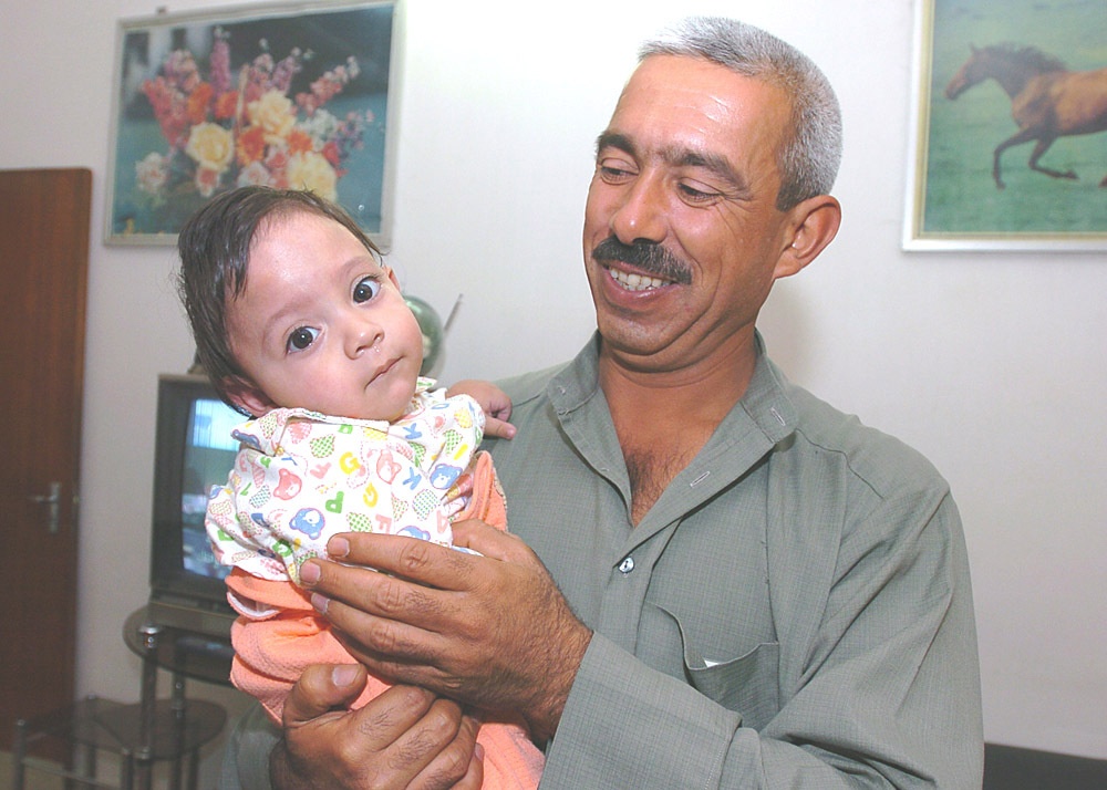 Tariq held by his father, Ziyad Ibraheem