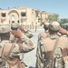 the playing of the Iraqi national anthem during their graduation ceremony