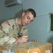 Spc. Mostad fills out a customs form for a package
