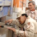 Spc. Davis checks for fuel in an Iraqi truck