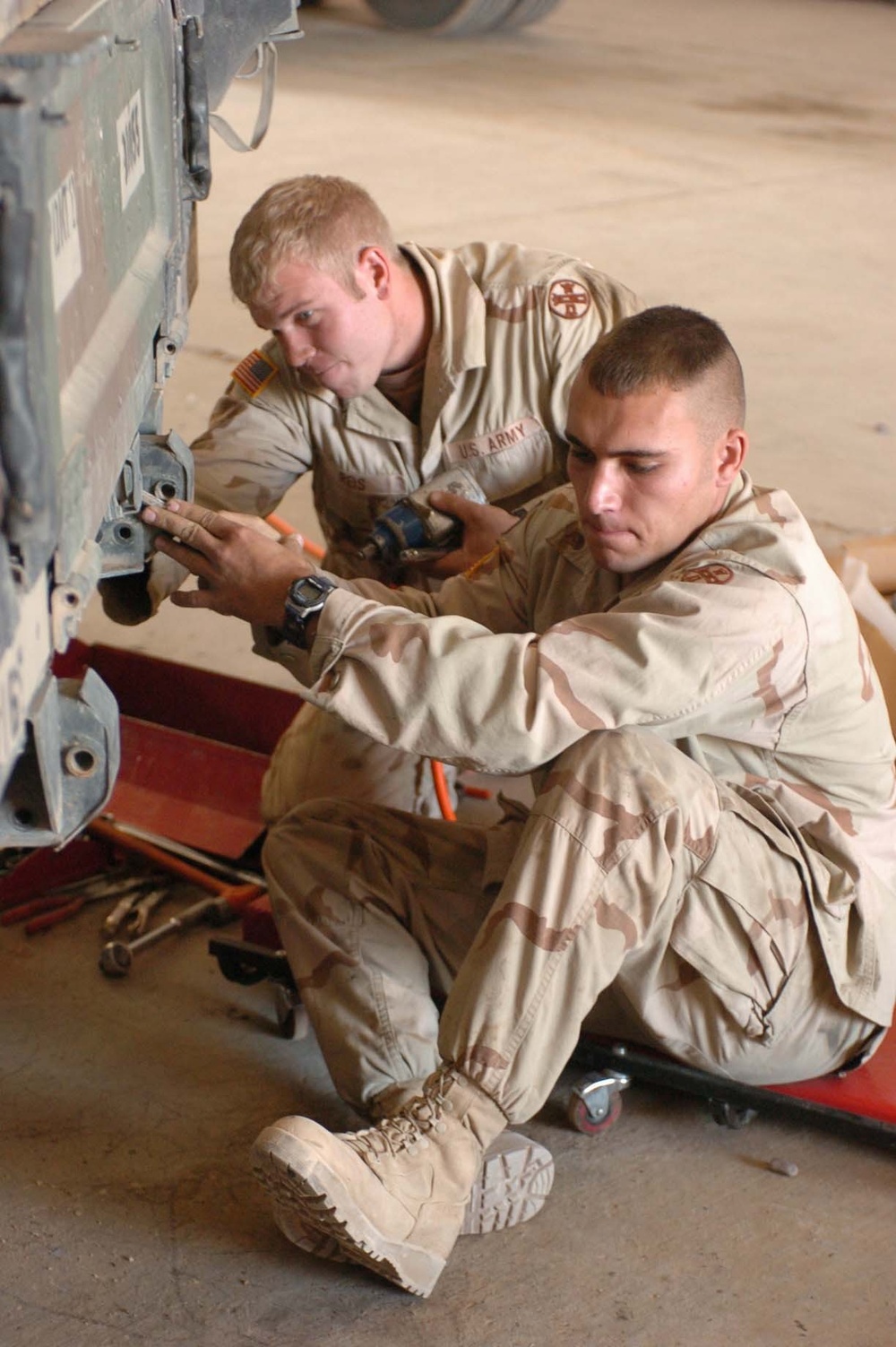 216th Engineer work on the back of a humvee