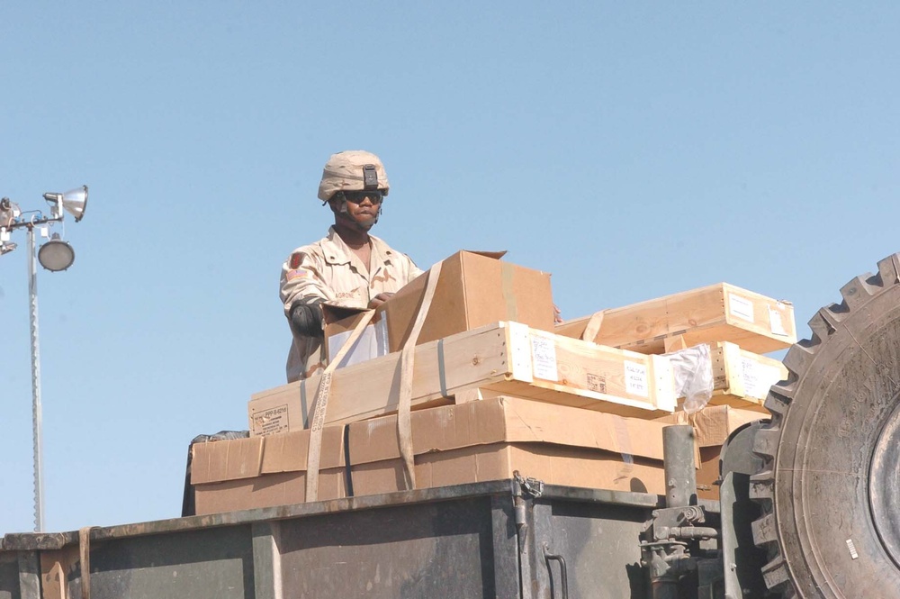 SPC Elvin Lagrone straps down a load of cargo