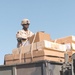 SPC Elvin Lagrone straps down a load of cargo