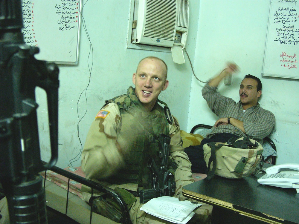 Staff Sgt. Cook talks to a civilian police adviser