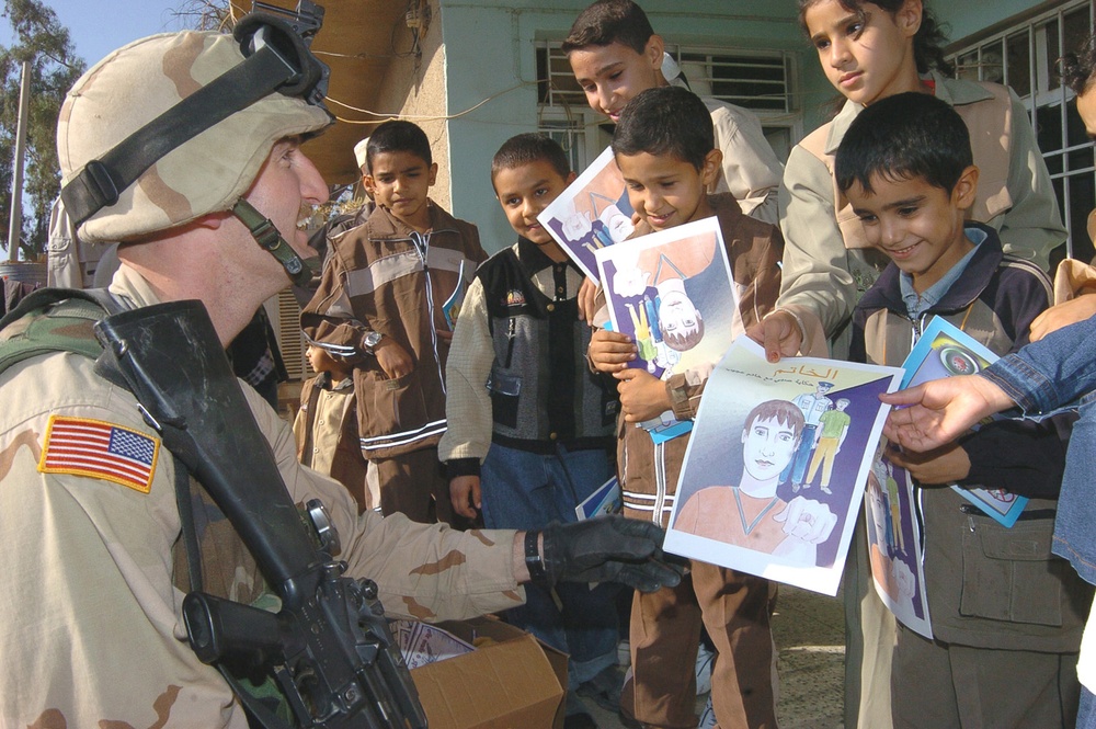 Sgt. Abner hands out coloring books