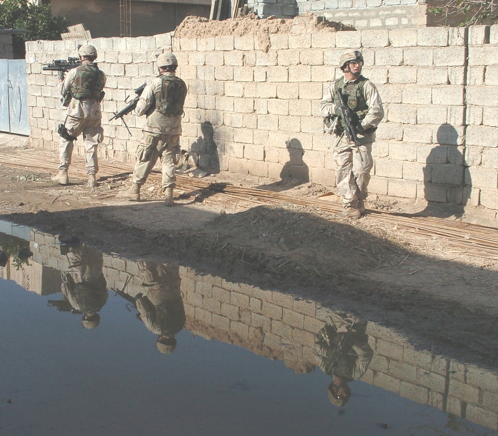 Soldiers conduct a dismounted patrol in Hawija