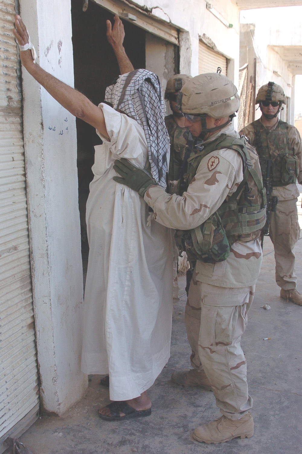Staff Sgt. Jesse Wyant searches an Iraqi man
