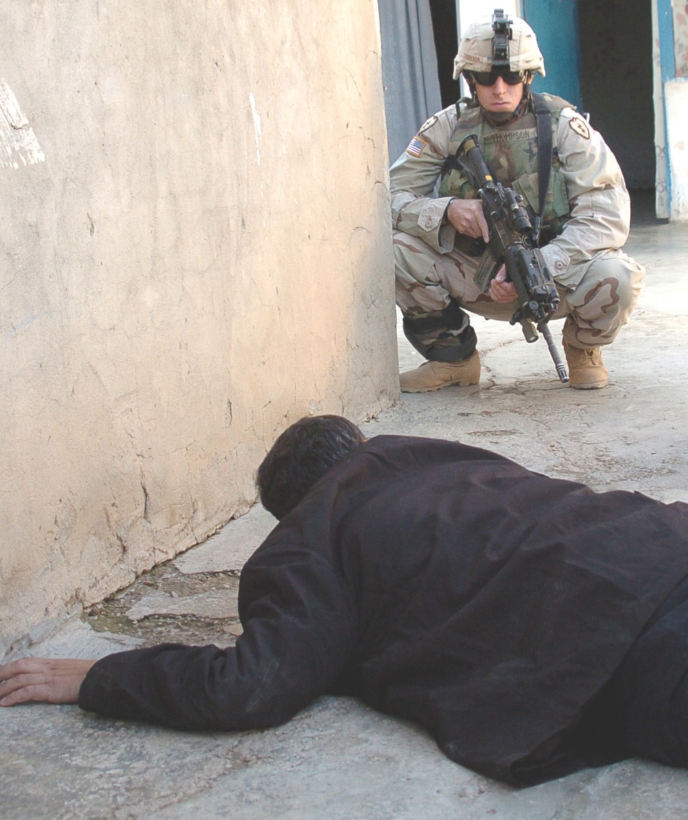 Spc. Thompson watches over a suspected terrorist