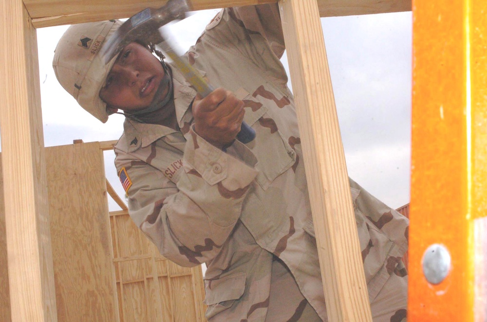 Sgt. Slick constructs the walls of a new structure