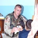 1st Lt. Samuel Wigley hands a (Beanie Baby) to a child
