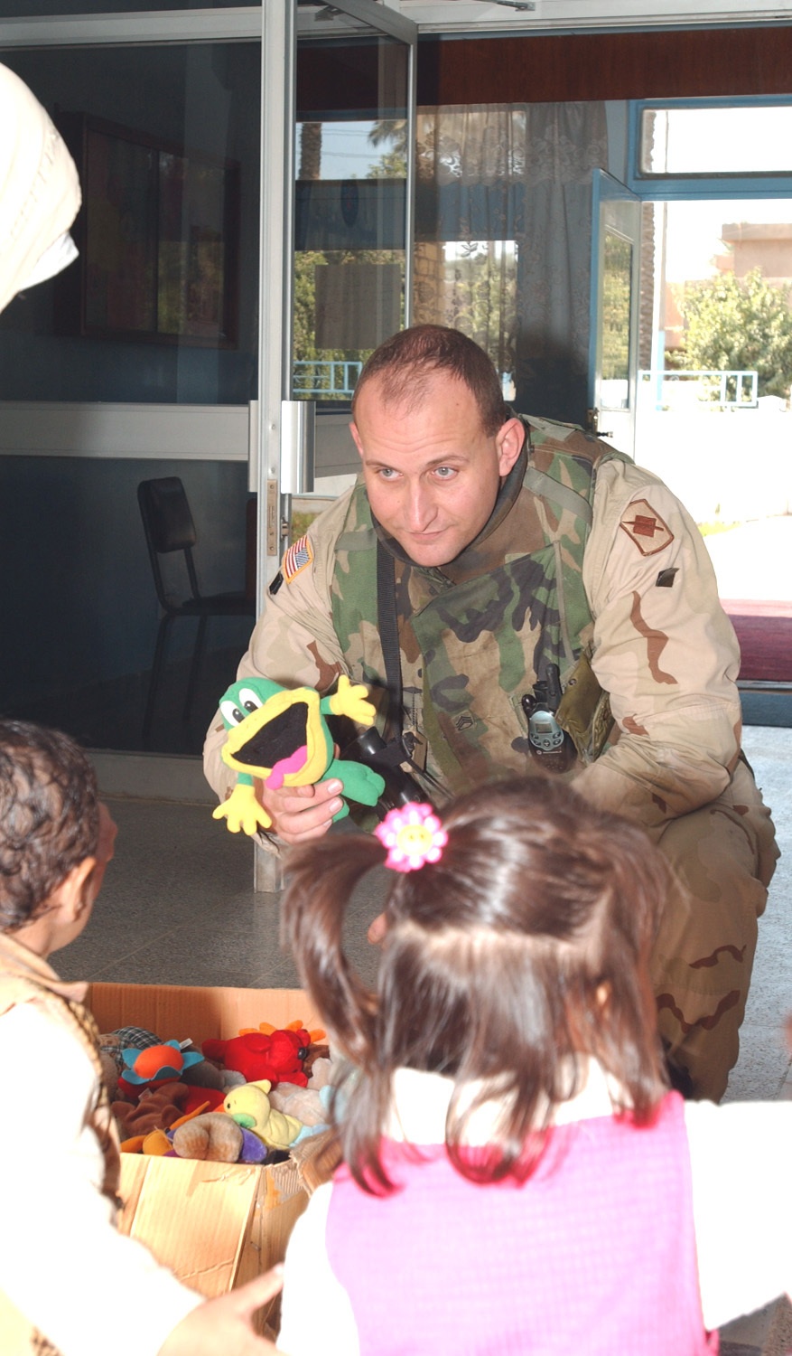 Staff Sgt. Scott Turner offers a stuffed frog