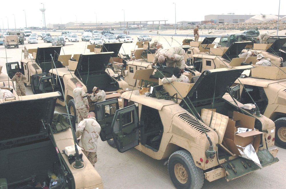 Soldiers work on their new M1114 Humvees