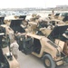Soldiers work on their new M1114 Humvees