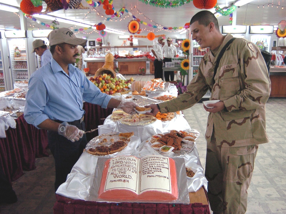 Gopi Krishna gives Sgt. Miguel Gallegos a slice of pumpkin pie