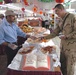 Gopi Krishna gives Sgt. Miguel Gallegos a slice of pumpkin pie