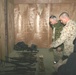 The Secretary of the Navy looks at a weapons cache