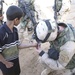 Spc David Maples administers first aid to a local