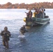 Marines wade through the waters of the Euphrates River