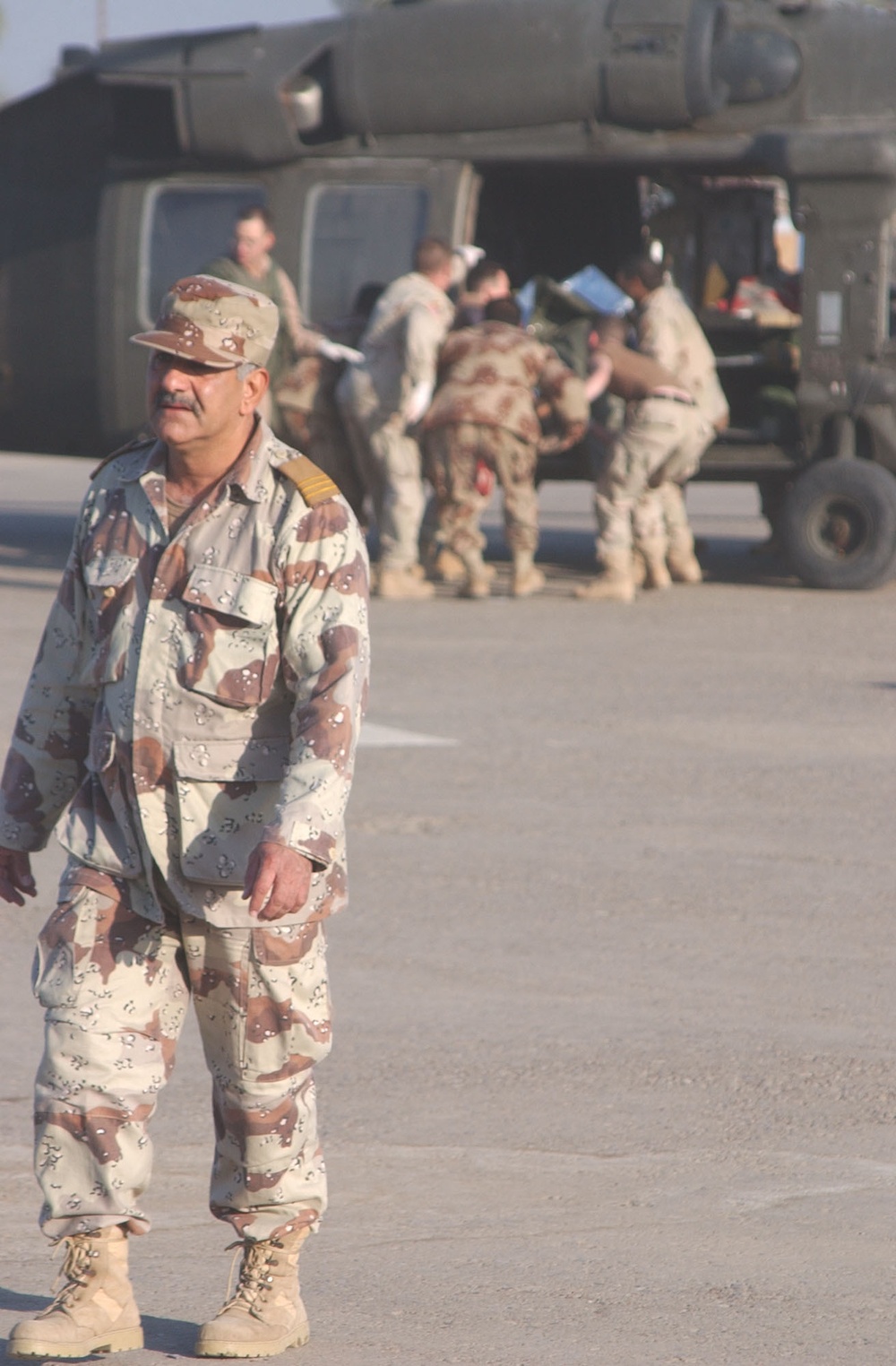 A Soldier walks away after putting a fellow Guardsman on a mediv