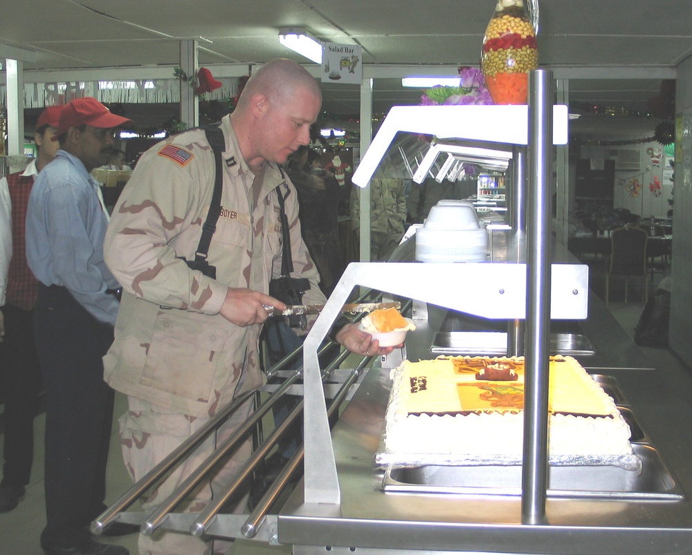 Capt. Al Boyer cuts a slice of cake