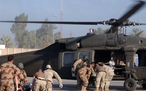 Medics carry wounded ING soldiers to a helicopter