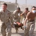 Soldiers carry an injured Iraqi to a medivac