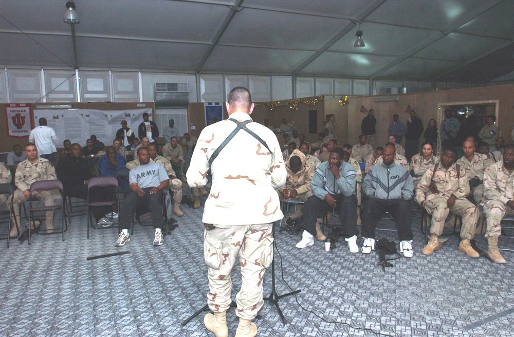 Soldiers listen to a love poem by Staff Sgt. Shawn Smith
