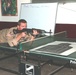 Sgt. Les Coash assumes a good prone position