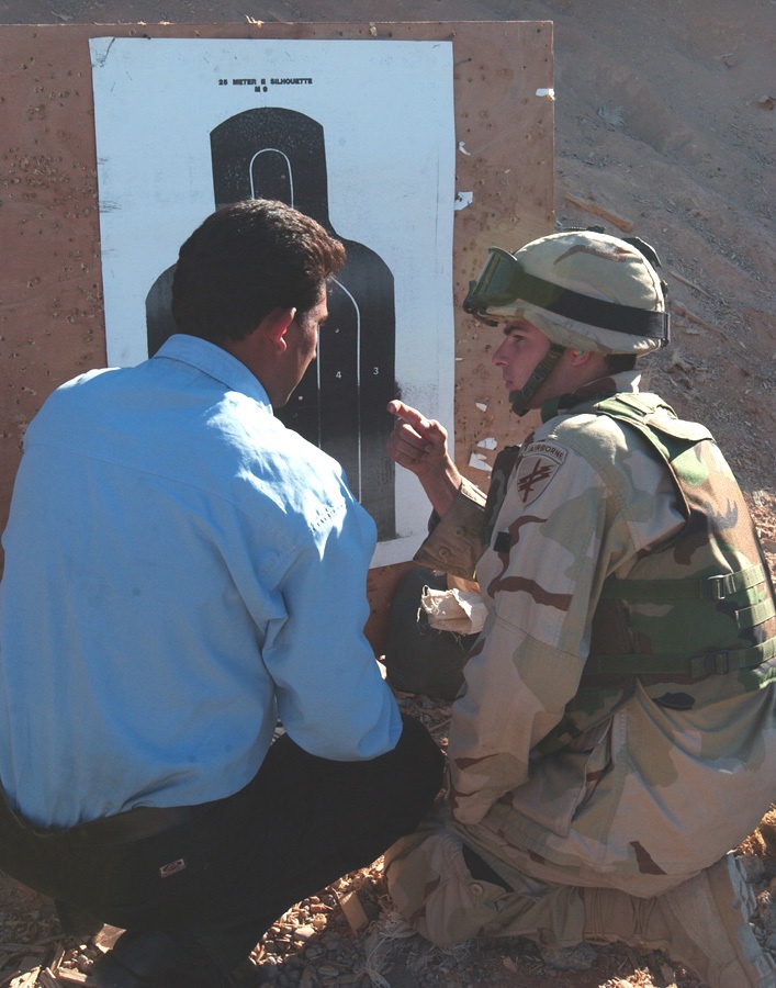 Spc. Brendan Piper uses hand signals