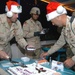 Soldiers grab a piece of cake after the holiday card lighting ce