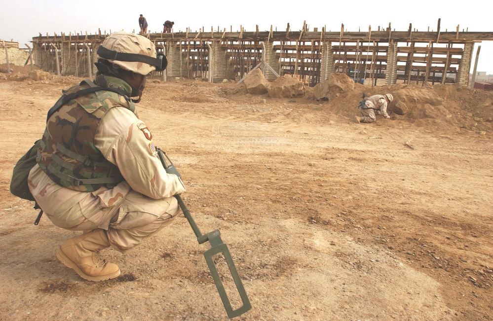 Staff Sgt Mike digs for suspected unexploded ordnance
