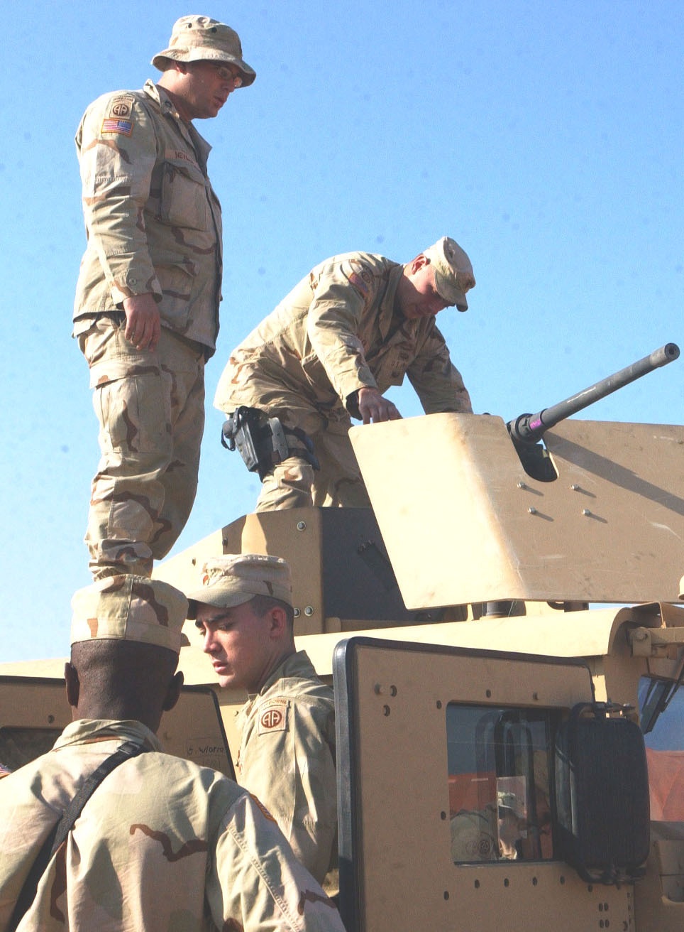 Soldiers conduct pre-combat checks on their Humvees