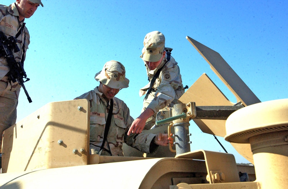 Soldiers conduct pre-combat checks on their Humvees