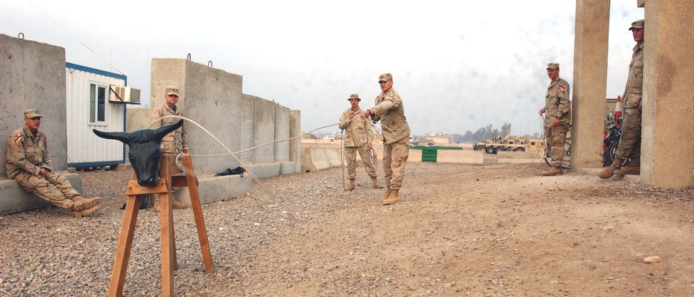 Spc. Christopher Rose practices his roping techniques
