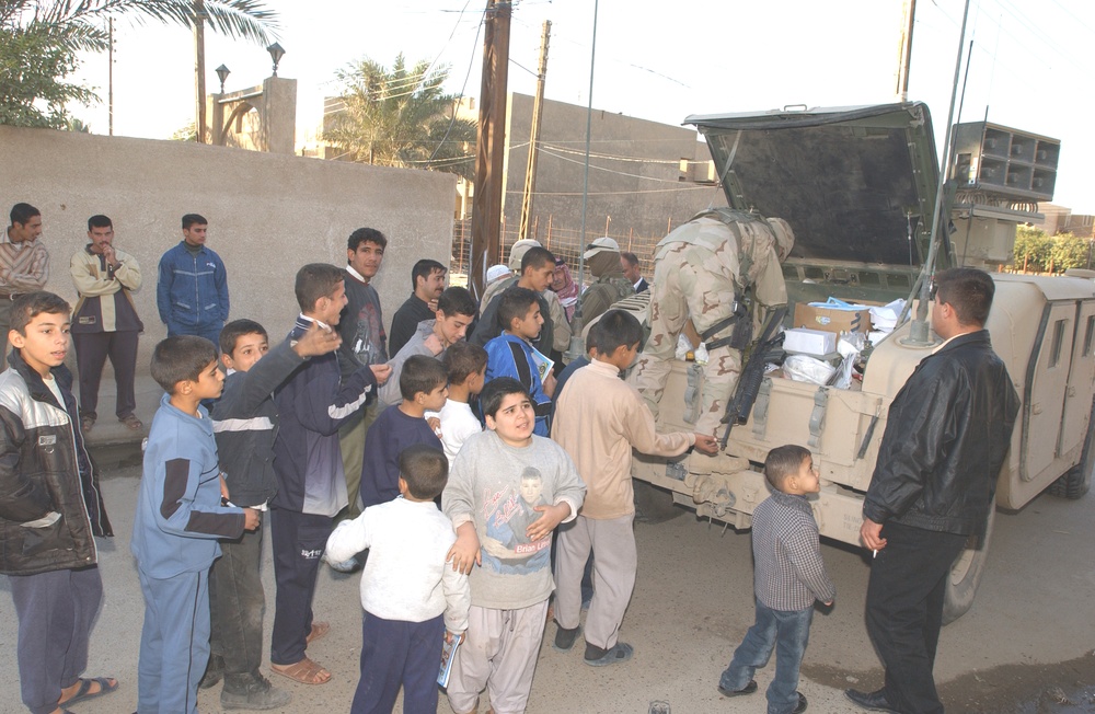 Eager Iraqi children wait in line to receive a soccer ball