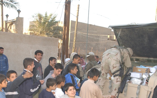 Eager Iraqi children wait in line to receive a soccer ball