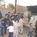 Eager Iraqi children wait in line to receive a soccer ball