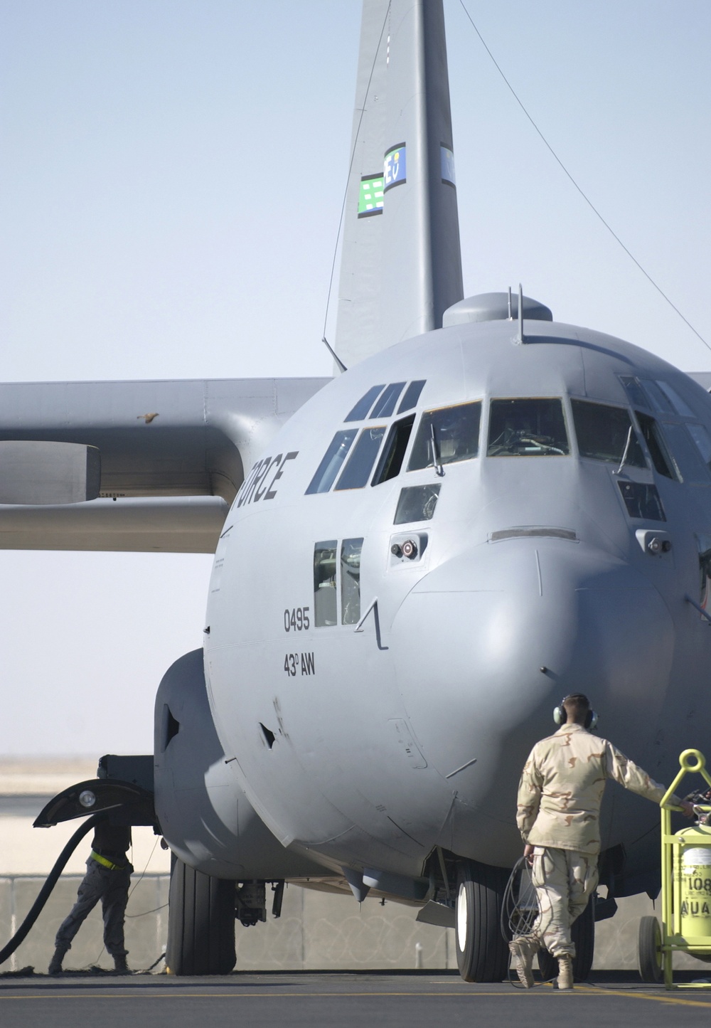 Crew chiefs  refuel a C-130