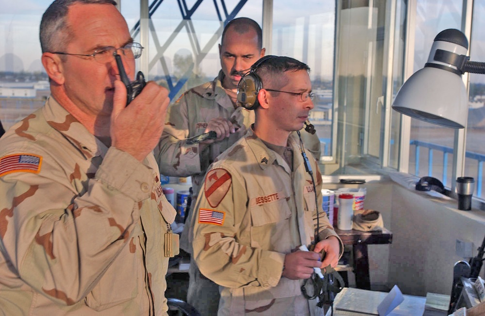 Soldiers look out of Taji Tower watching aircraft